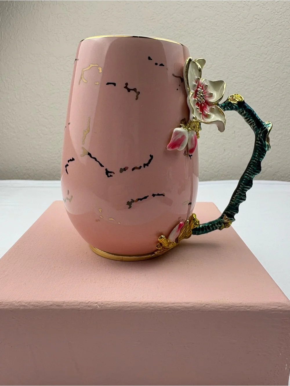 Pink ceramic enamel mug decorated with a 3D floral, rhinestones, and gold trim.
